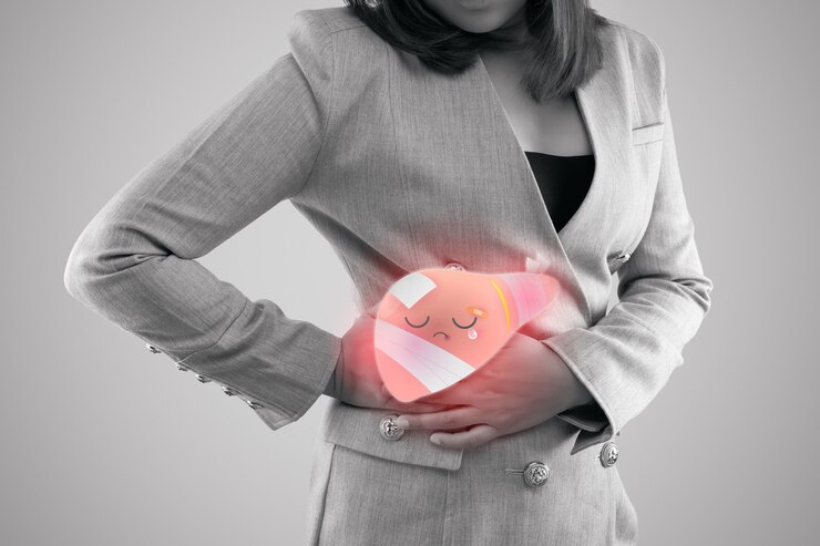 A woman has her hands on belly side with liver pain highlighted