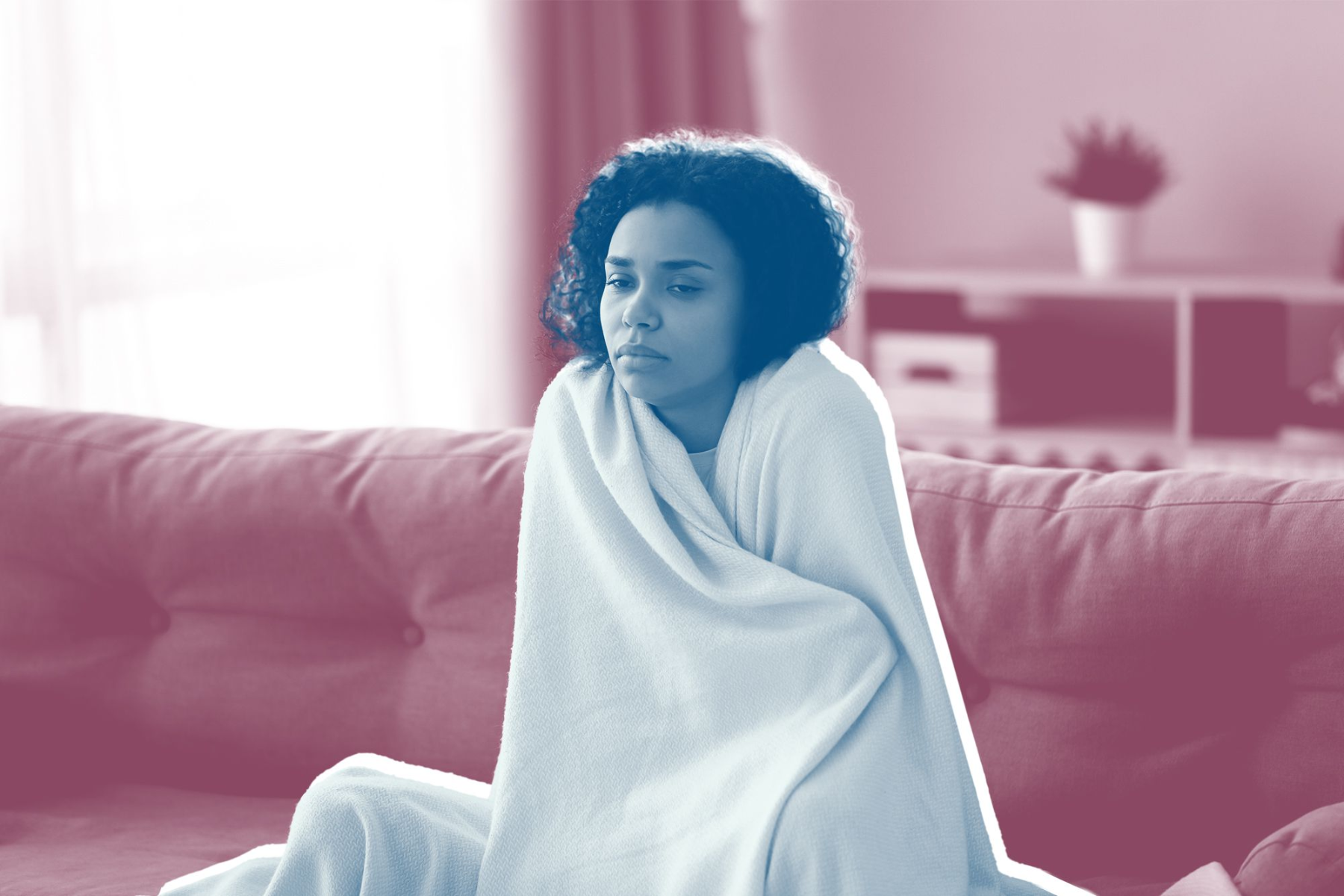 A woman who has a blue effect on her blanket becomes cold
