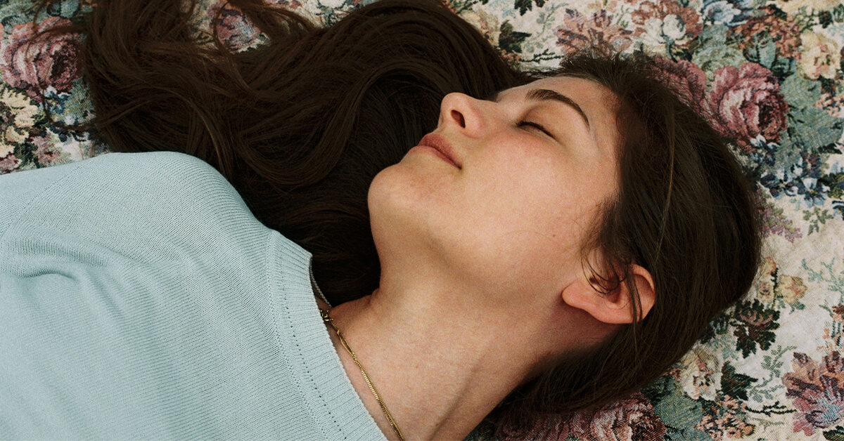 A girl wearing a light blue shirt and sleeping
