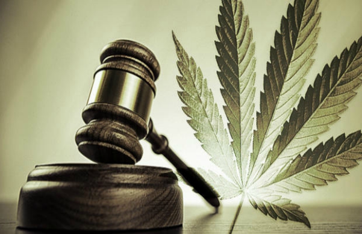 A wooden gavel and a cannabis leaf