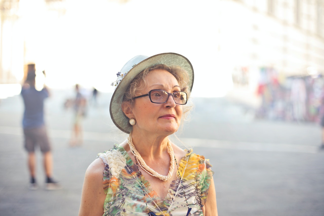 Woman in Pastel Color Sleeveless Shirt and White Sunhat