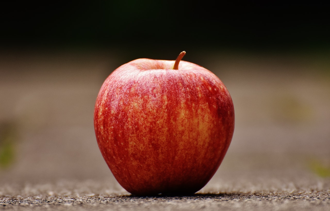Red Apple on Gray Pavement