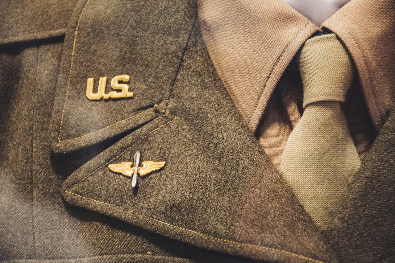 Gold-colored Us Brooch on Apparel