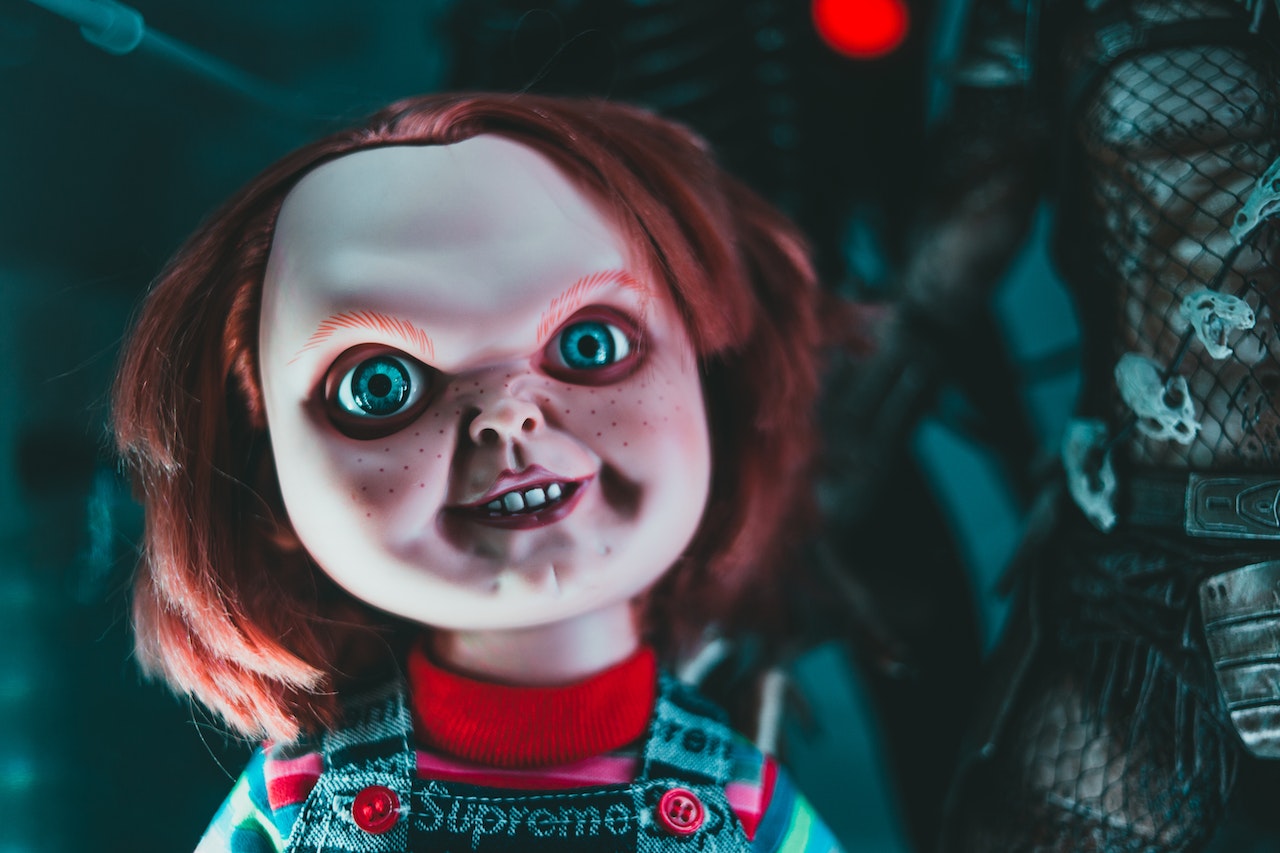 Doll with blue eyes and freckles on its terrible face