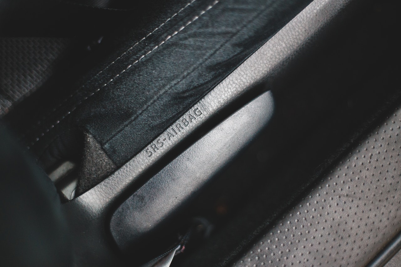 Airbag inscription on car seat near lever
