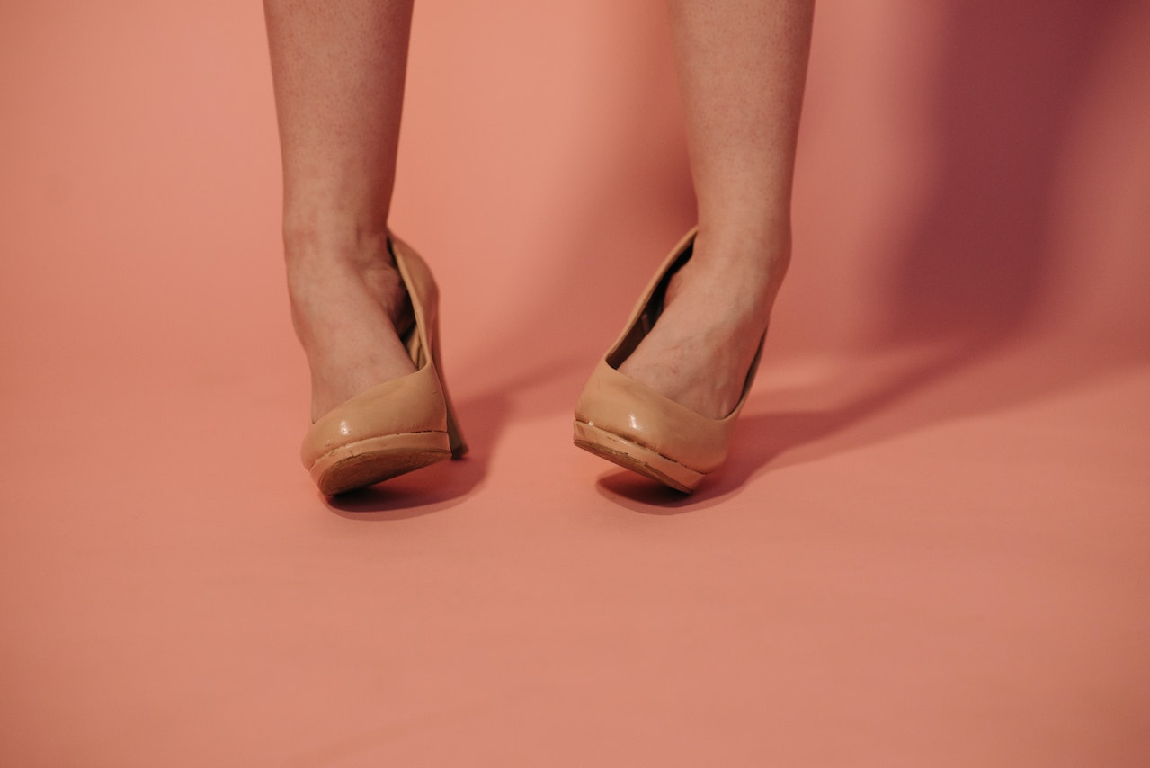 A Woman Wearing Brown High Heels Twisting her Ankles