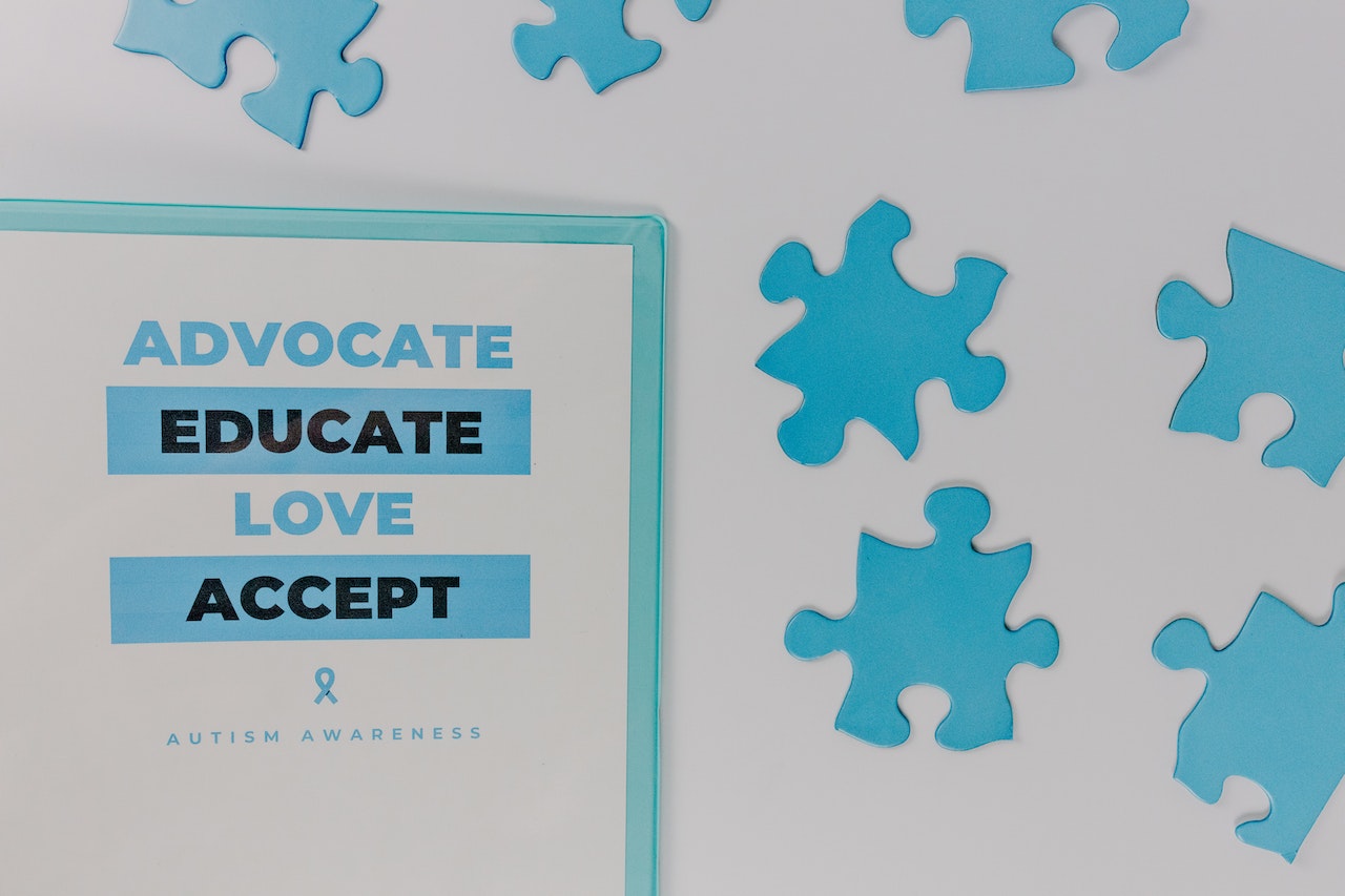 Autism Awareness Poster And Blue Jigsaw Puzzle Pieces
