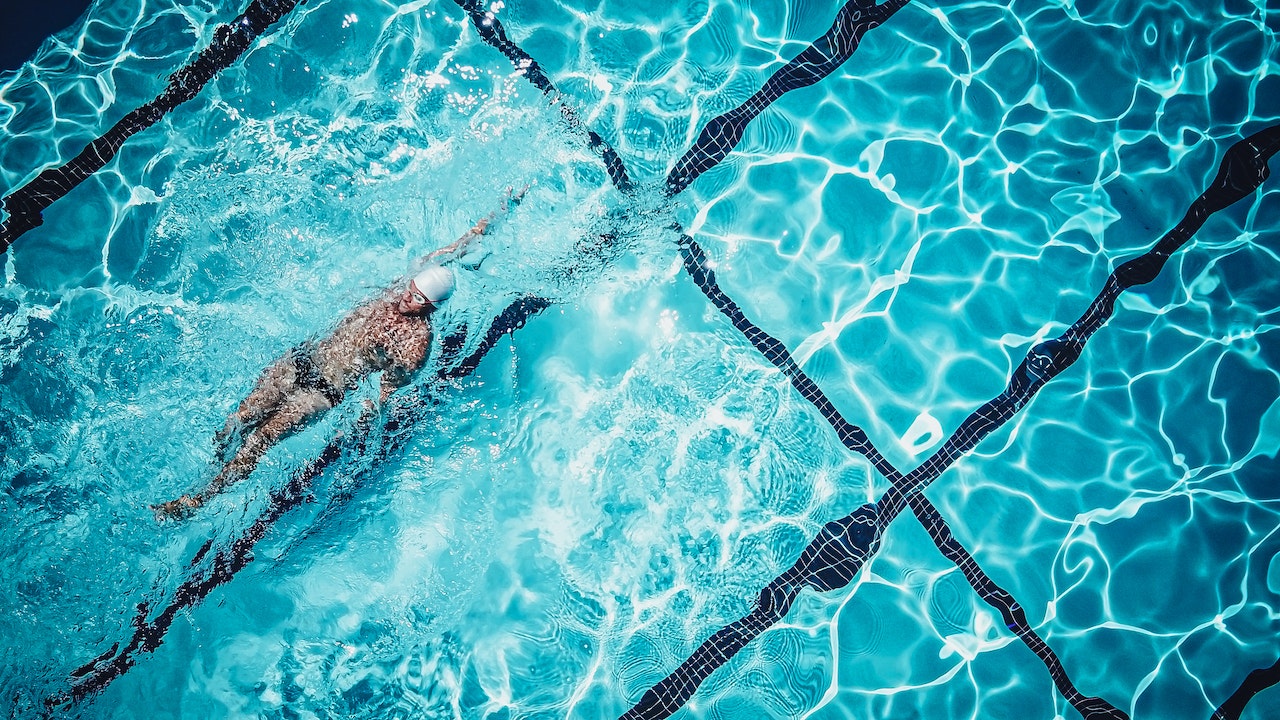 A Person Swimming In Backstroke Position In the Pool