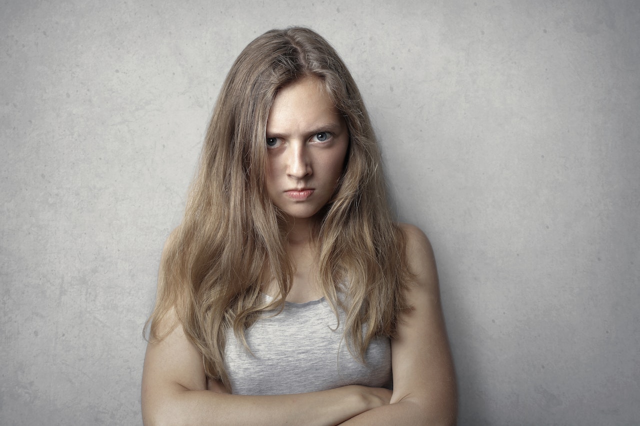 Woman Crossing Her Arms With Angry Facial Expression