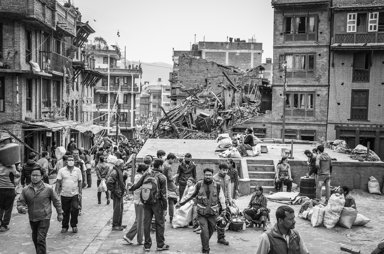 People Gathered Near Destroyed Buildings