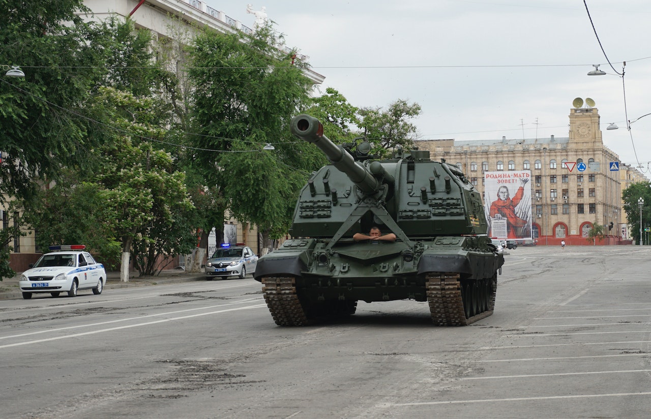 A Military Tank Driving In A Public Road