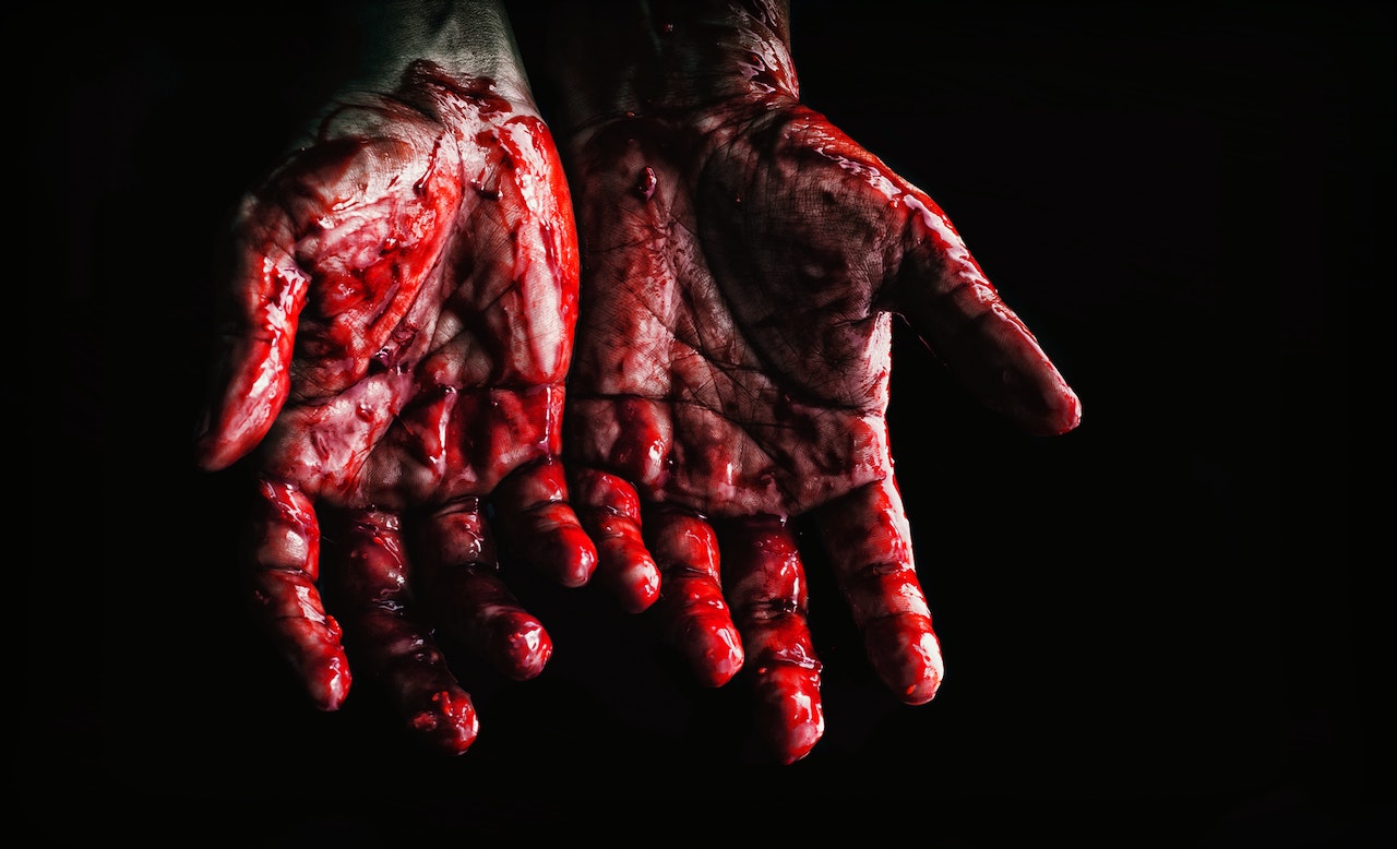 Person's Hands Covered with Blood