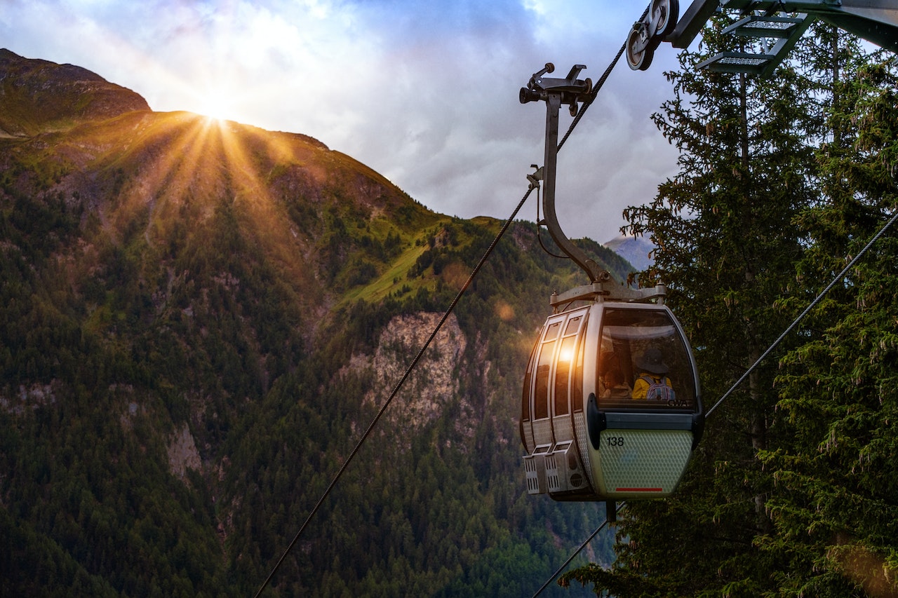 Cable Car Surrounded by Tree and Hill