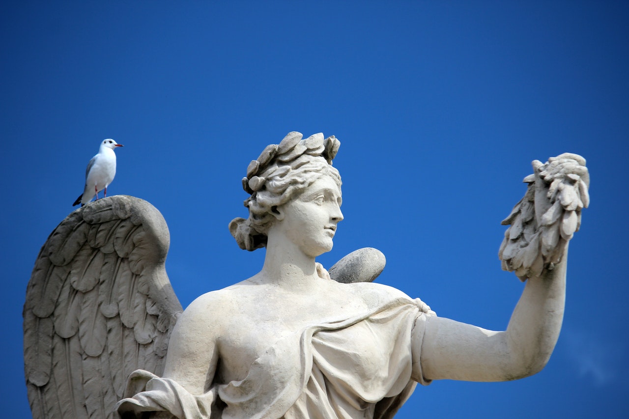 Bird Perched on an Angel Sculpture