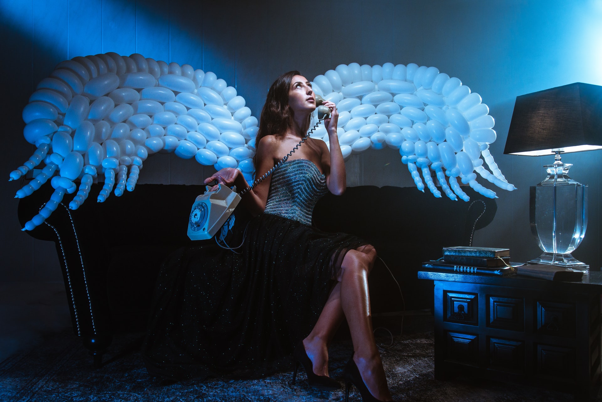 A Girl With White Angel Wings Holding A Telephone