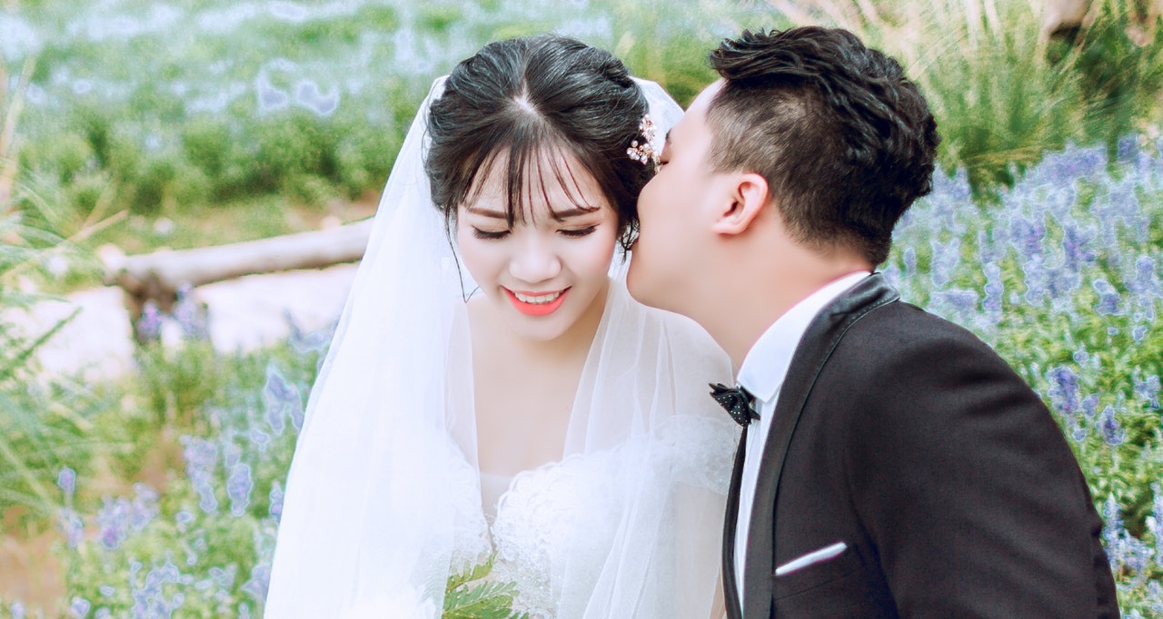 Groom Kissing His Bride on Her Left Cheek