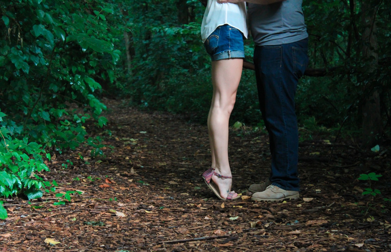 Man and Woman Standing Face to Face In The Forest