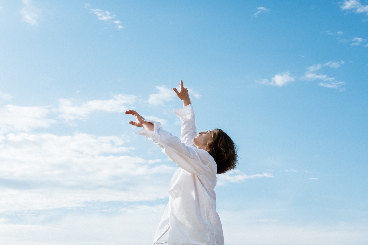 Woman in White Long Sleeve Shirt Raising Her Hands.jpg