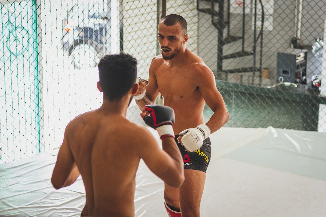 Two Topless Men Training in a Ring