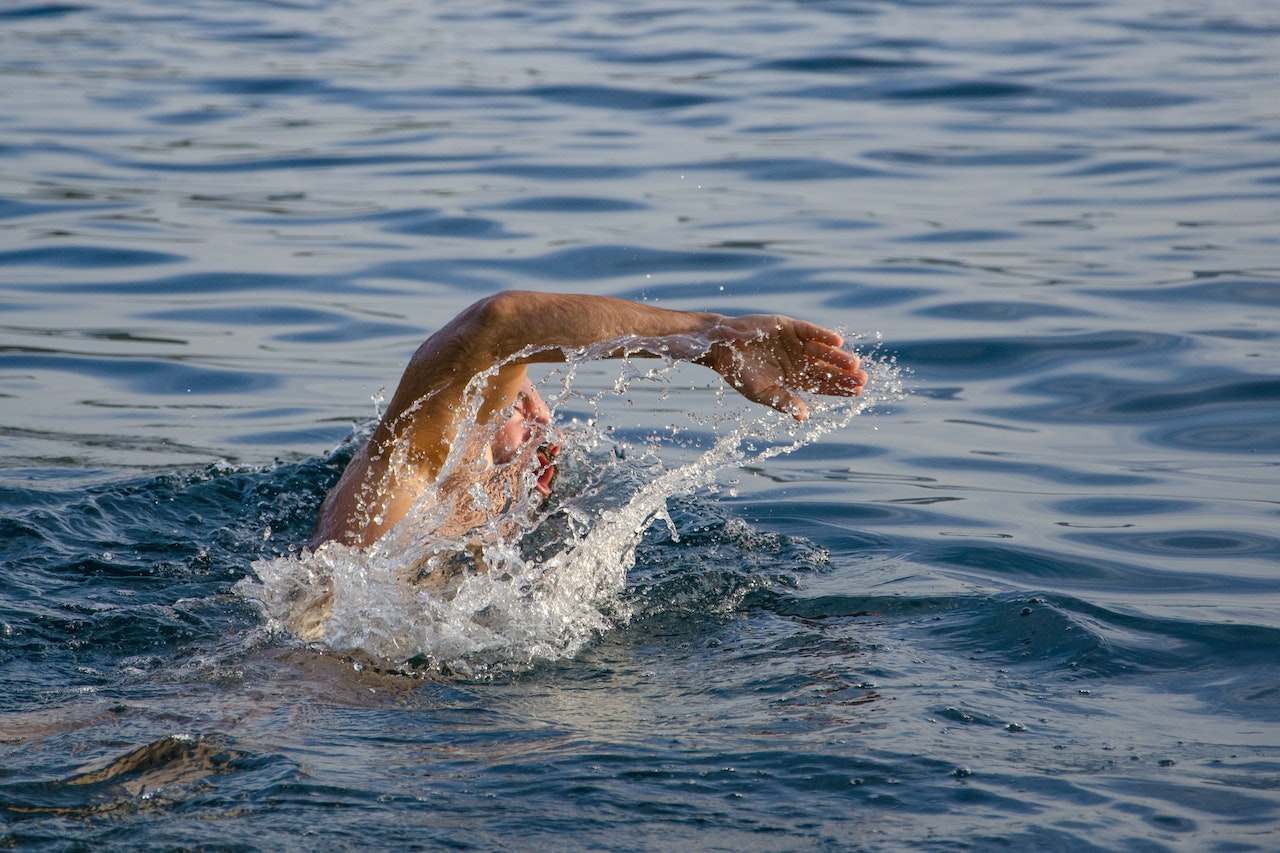 Person Swimming In The Sea And Doing Freestyle Strokes