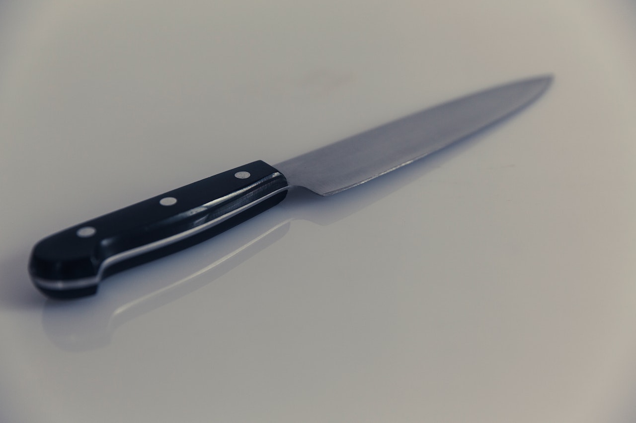 Knife With Black Handle Placed On A White Table
