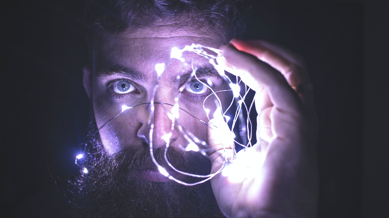 Person Holding String Lights near his face
