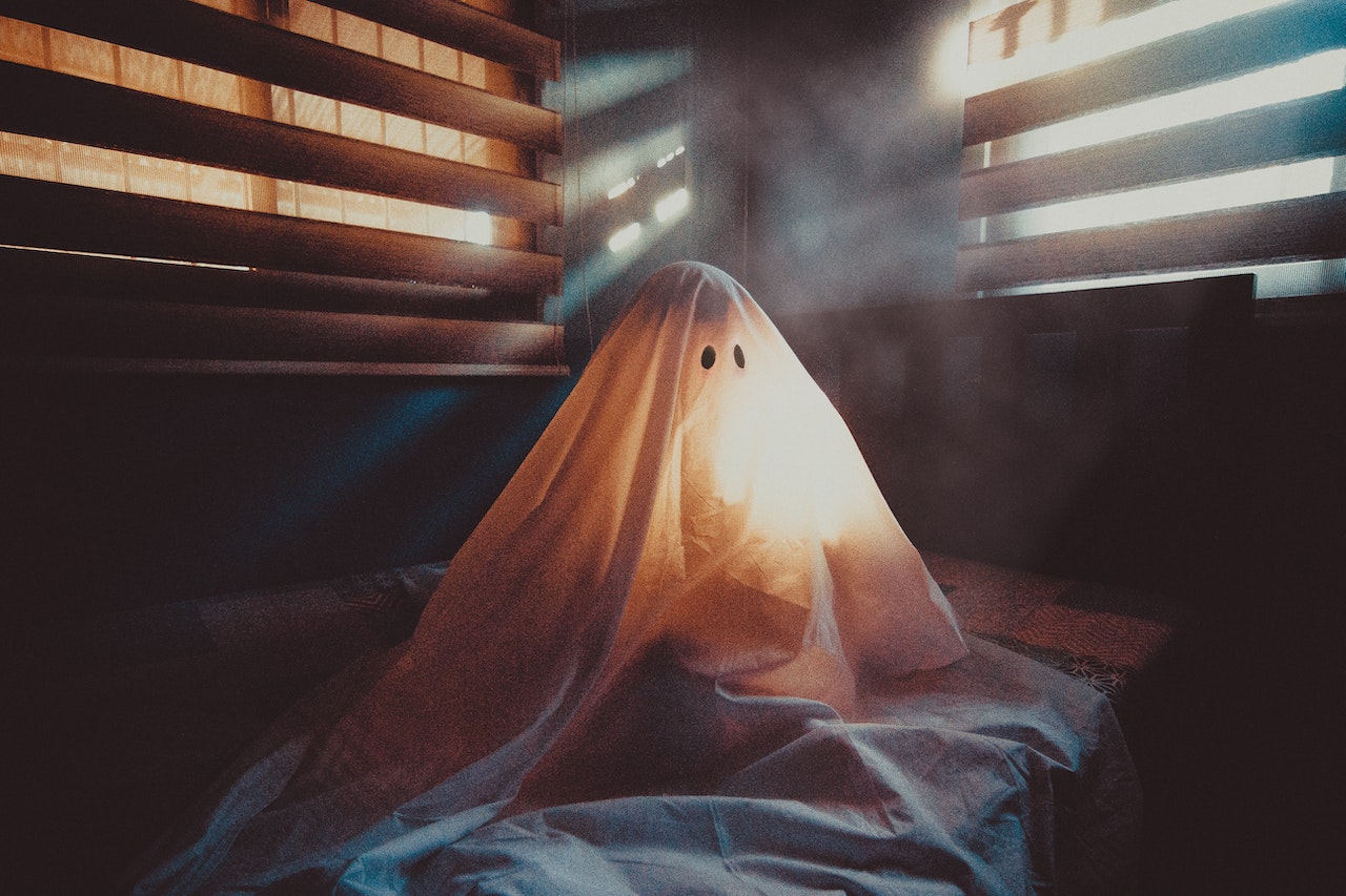 Spooky Ghost Sitting On Bed