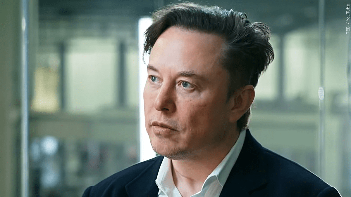 Elon Musk wearing a black suit with a white shirt