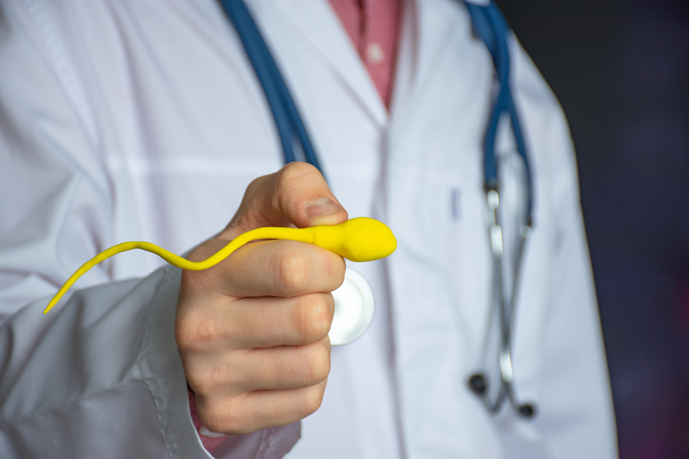 A Doctor Holding A Depiction Of Sperm