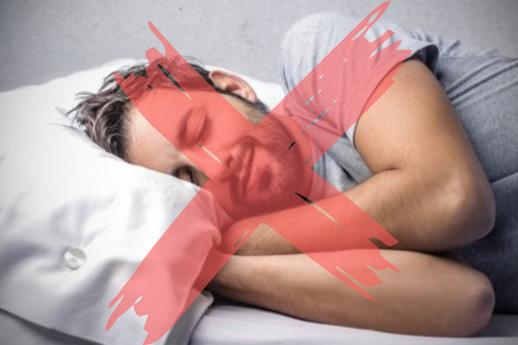 A sleeping man and a large red X sign