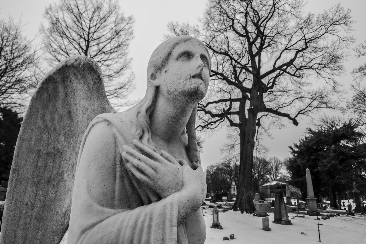 A statue of an angel in a cemetery