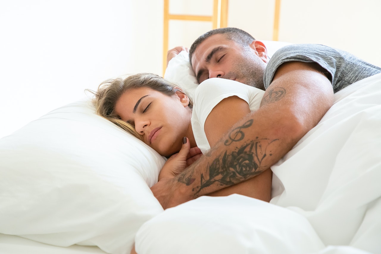 Man Hugging A Woman While Sleeping