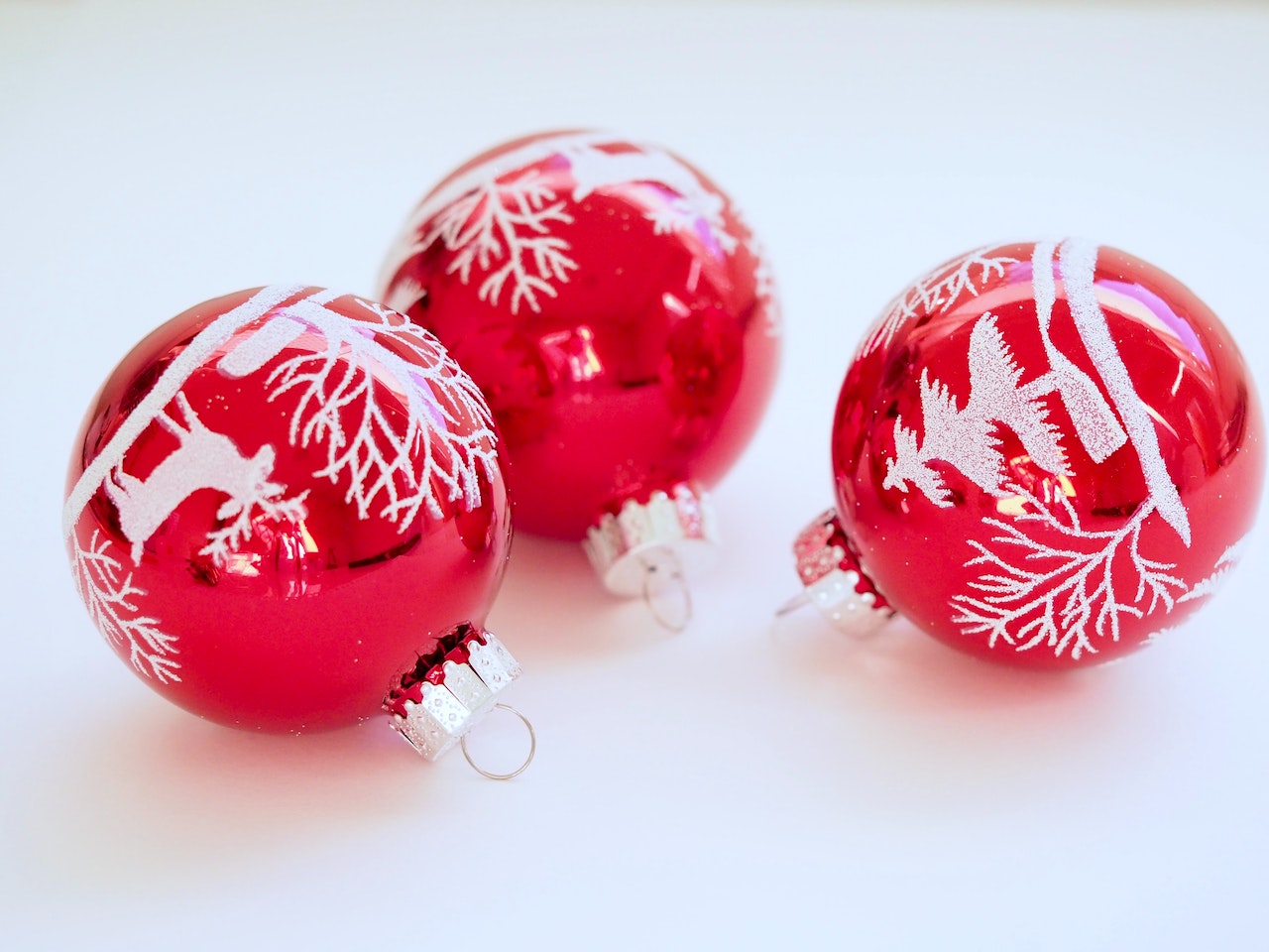 Three White-and-red Christmas Tree Printed Baubles