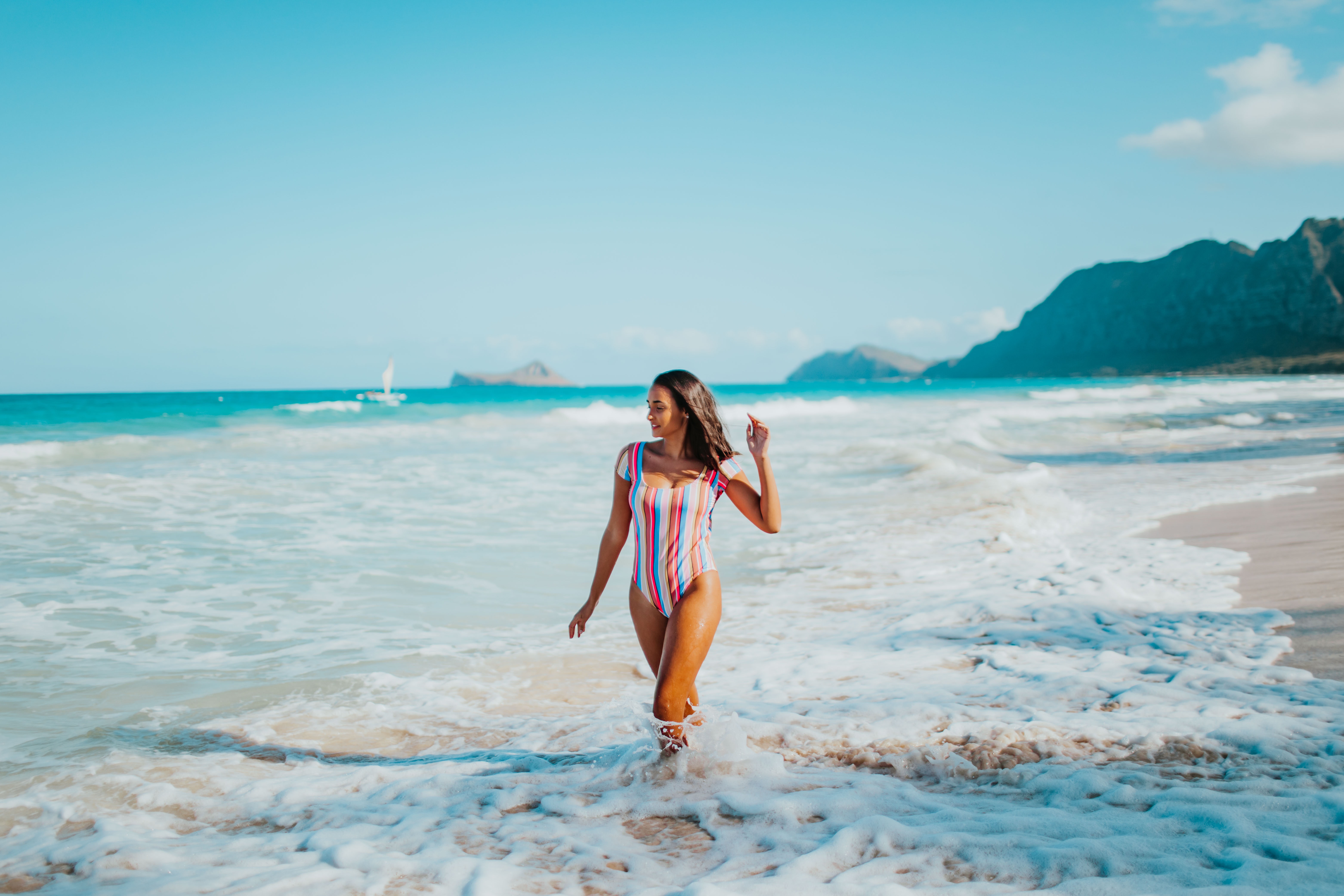 Woman in Multicolored Swim Suit Standing on Beach