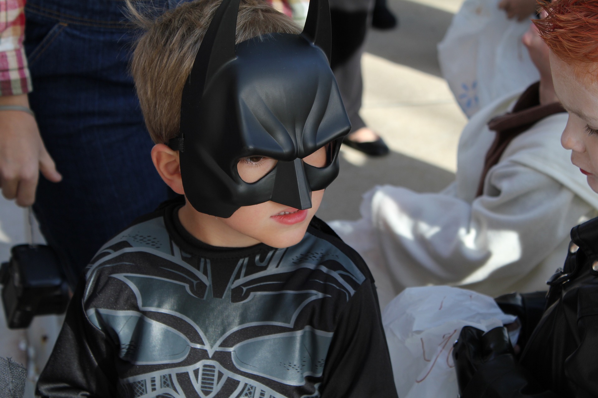 A kid wearing a batman costume on halloween