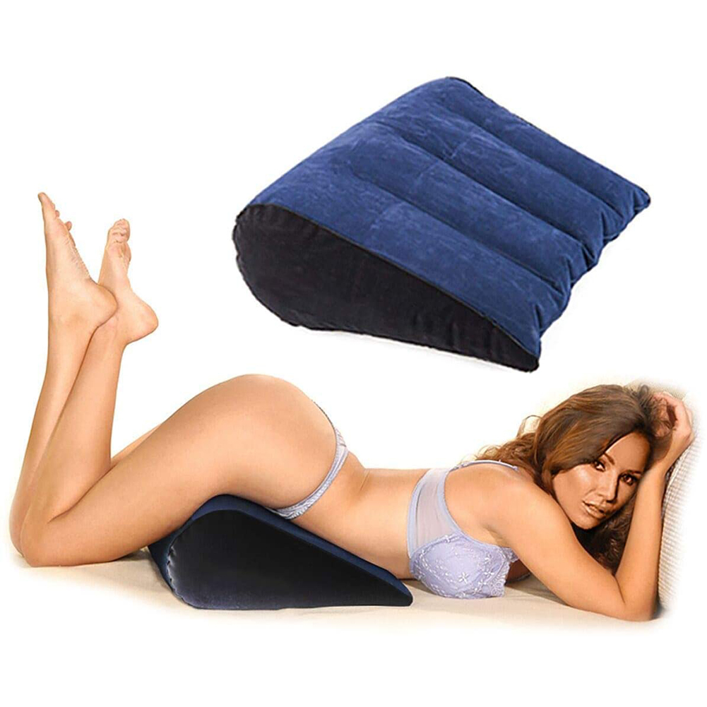 A woman wearing an underwear with a blue sex pillow beneath her