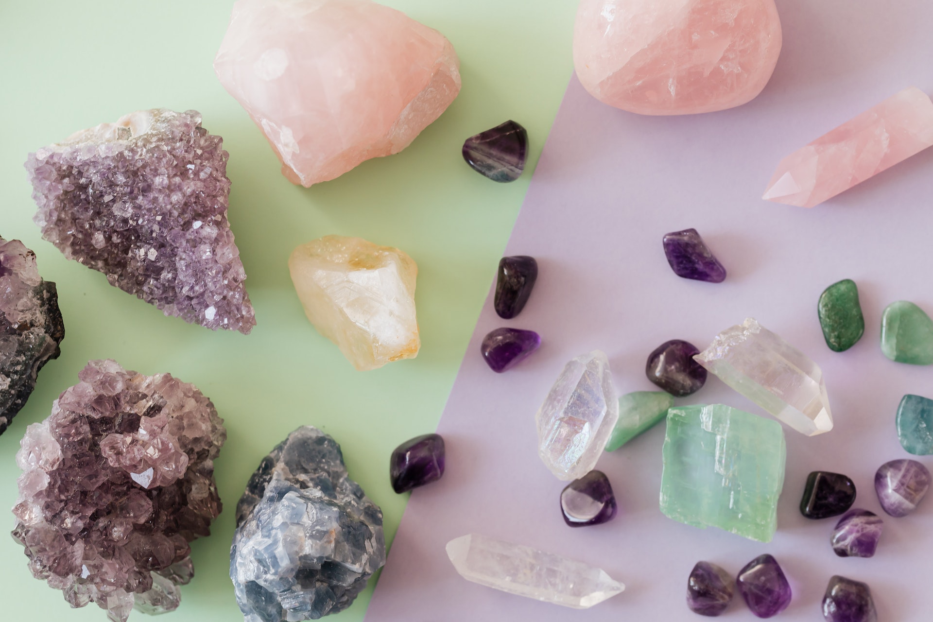 Uncut and cut crystals of different colors, shapes, and sizes laying close to each other