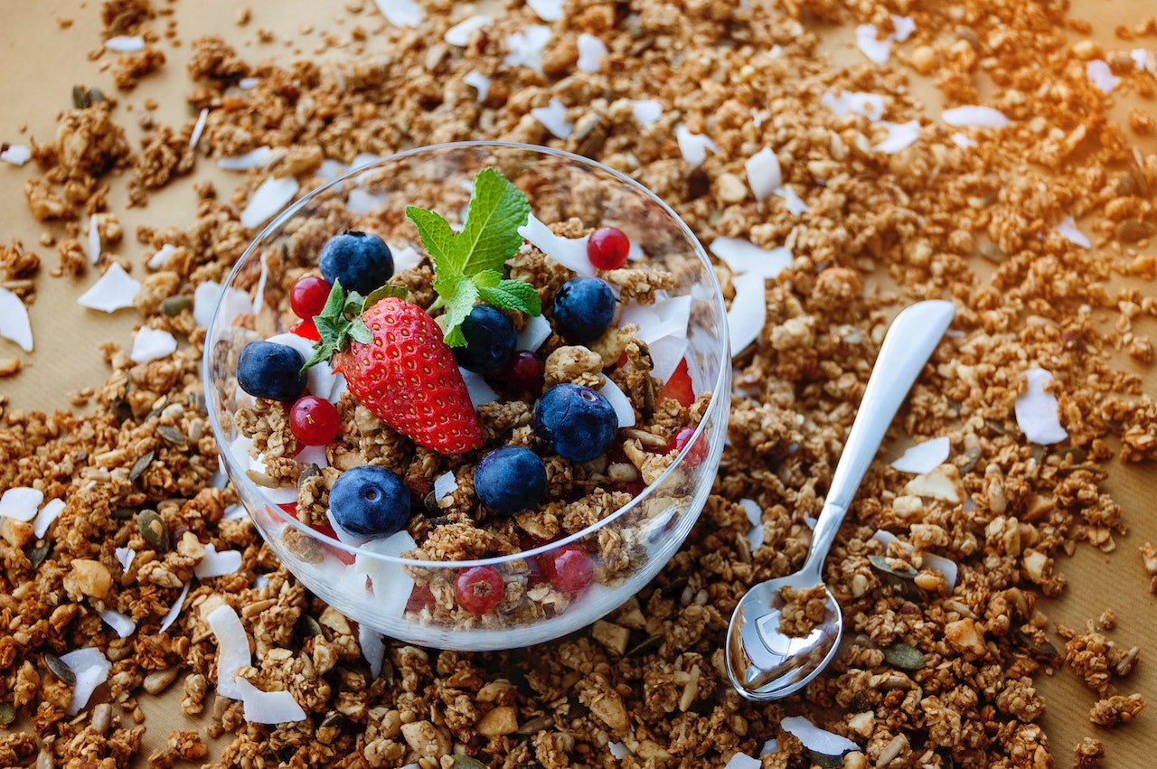 Strawberry And Blueberry with cereals On Clear Glass Bowl