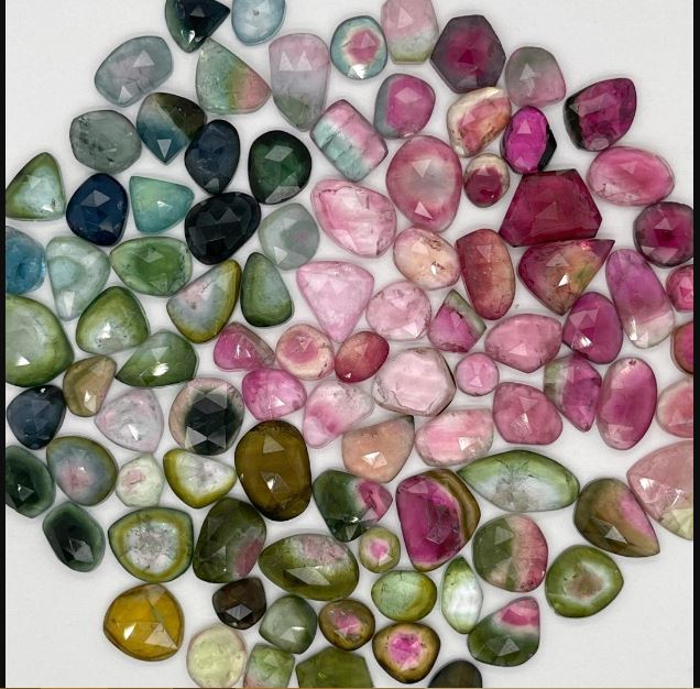 A collection of watermelon tourmaline stones placed beside each other 