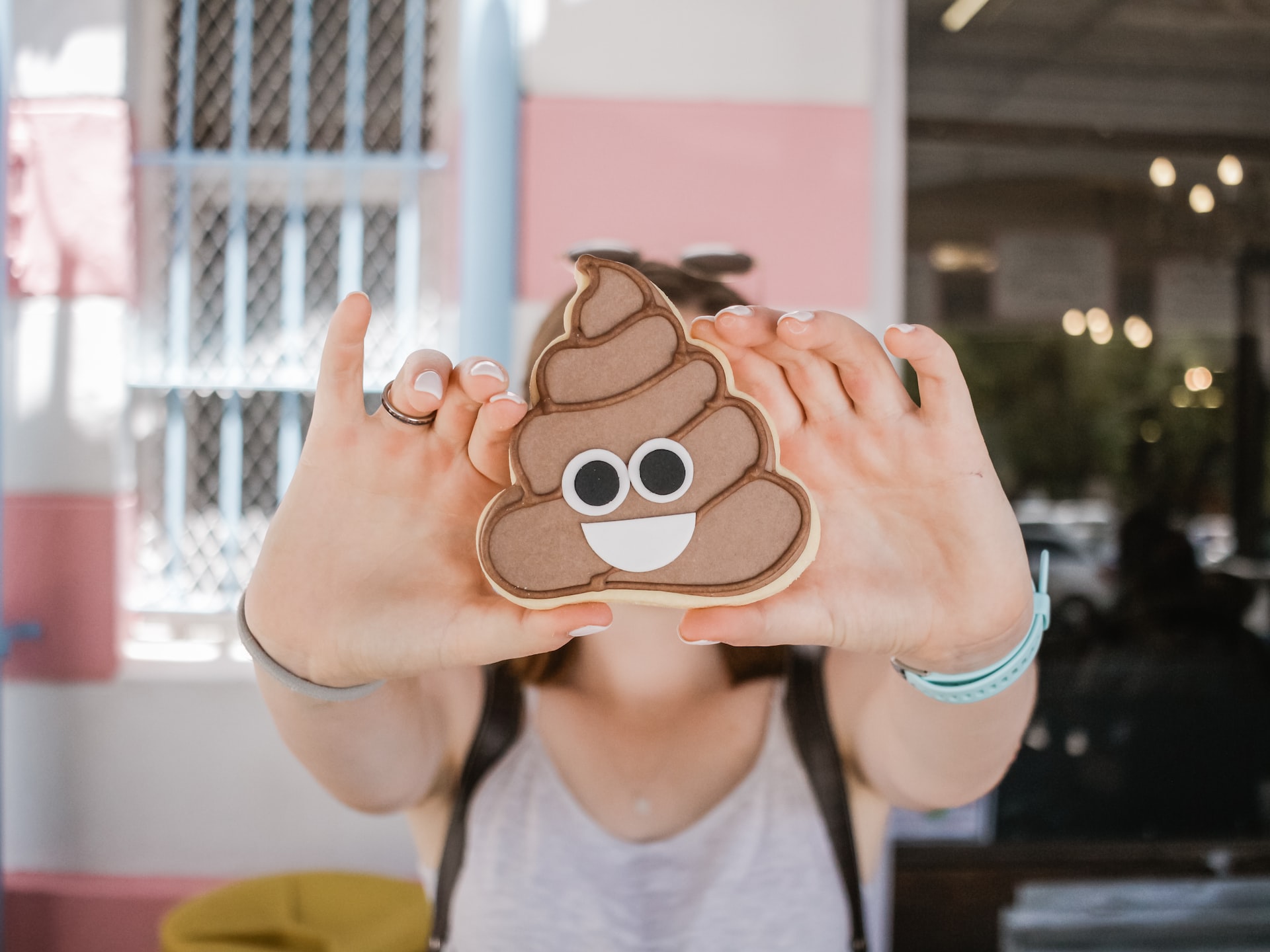 A Woman Holding A Poop Emoji