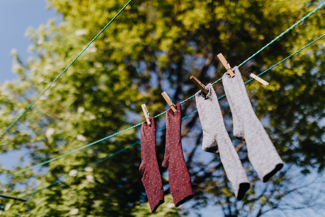 Set of various socks hanging on the clothesline using clothespins