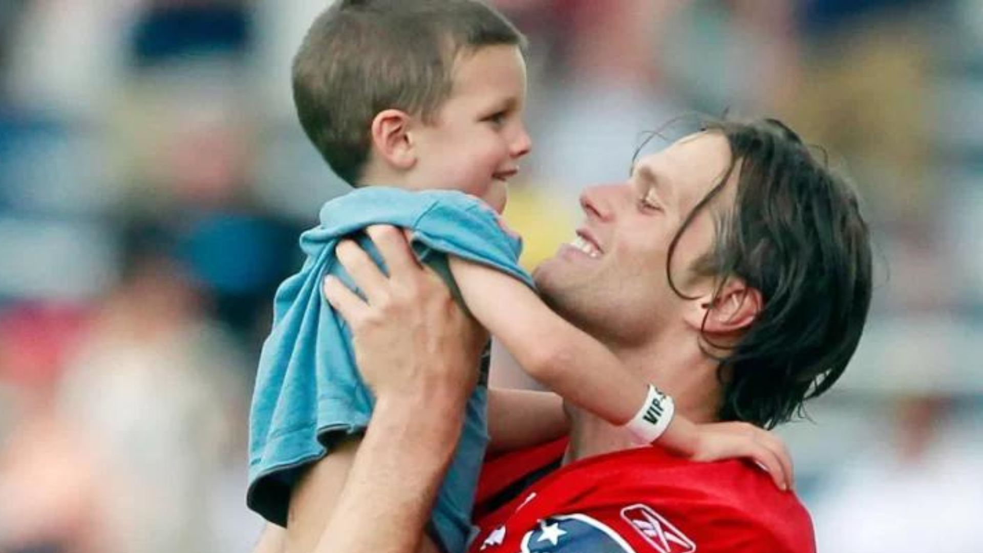 Tom Brady carrying his son John Edward 
