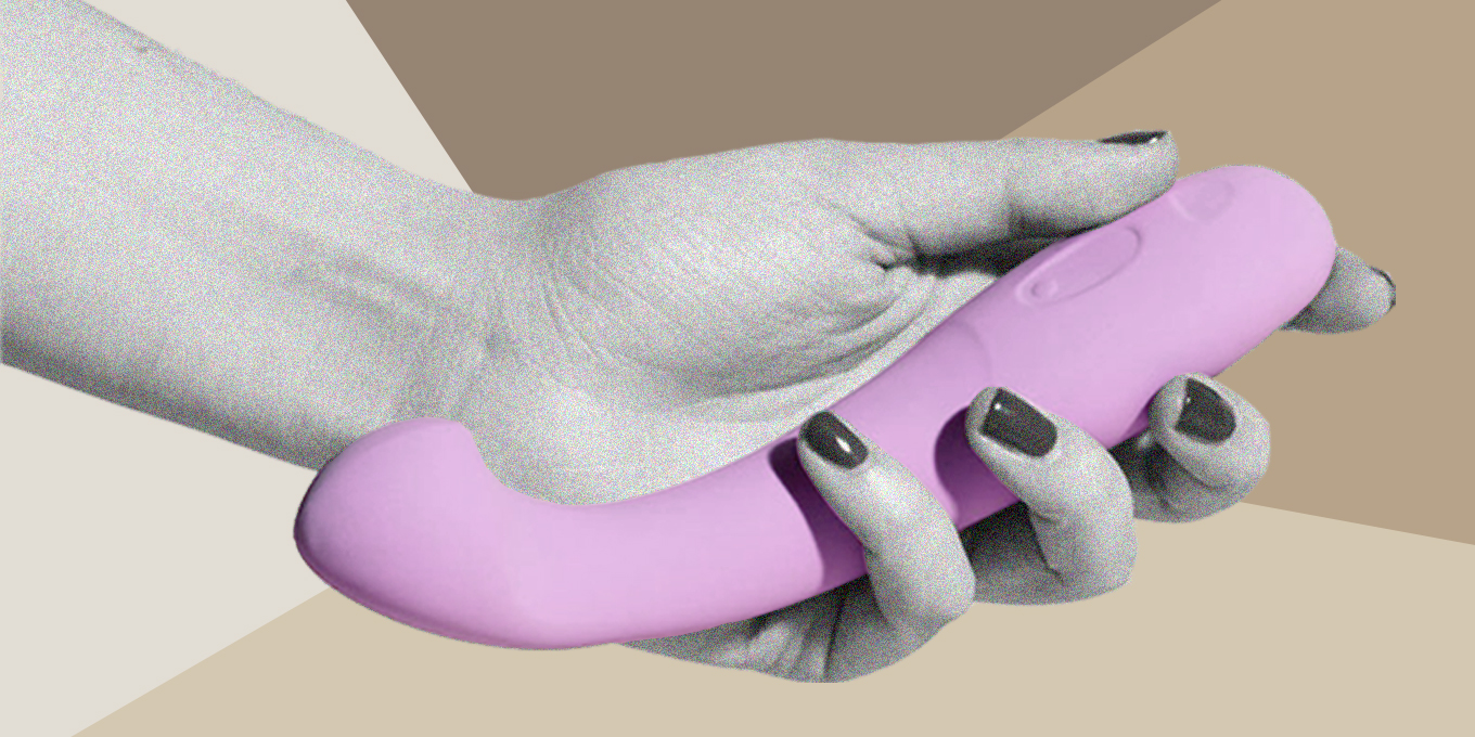 A woman holding a pink vibrator