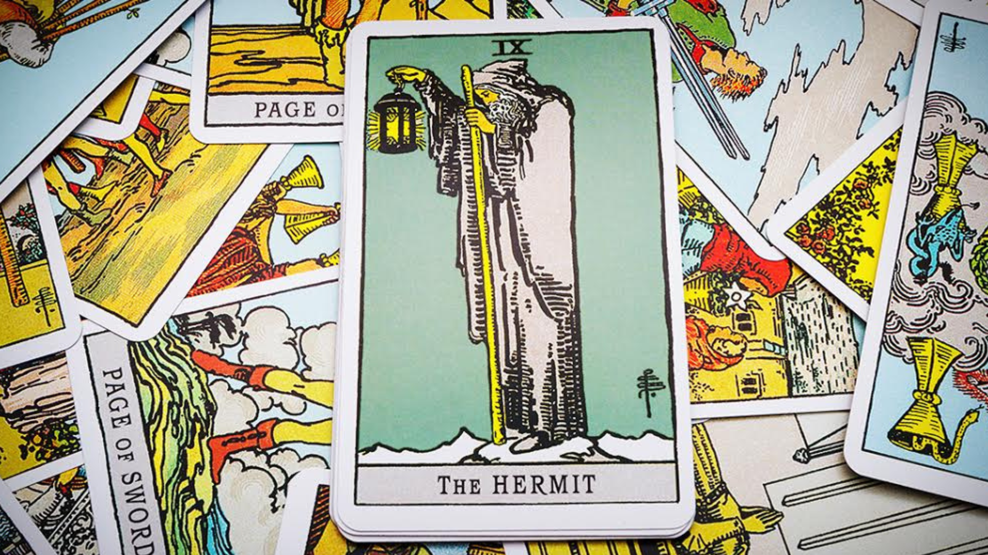 Several tarot cards with the Hermit Card in the middle