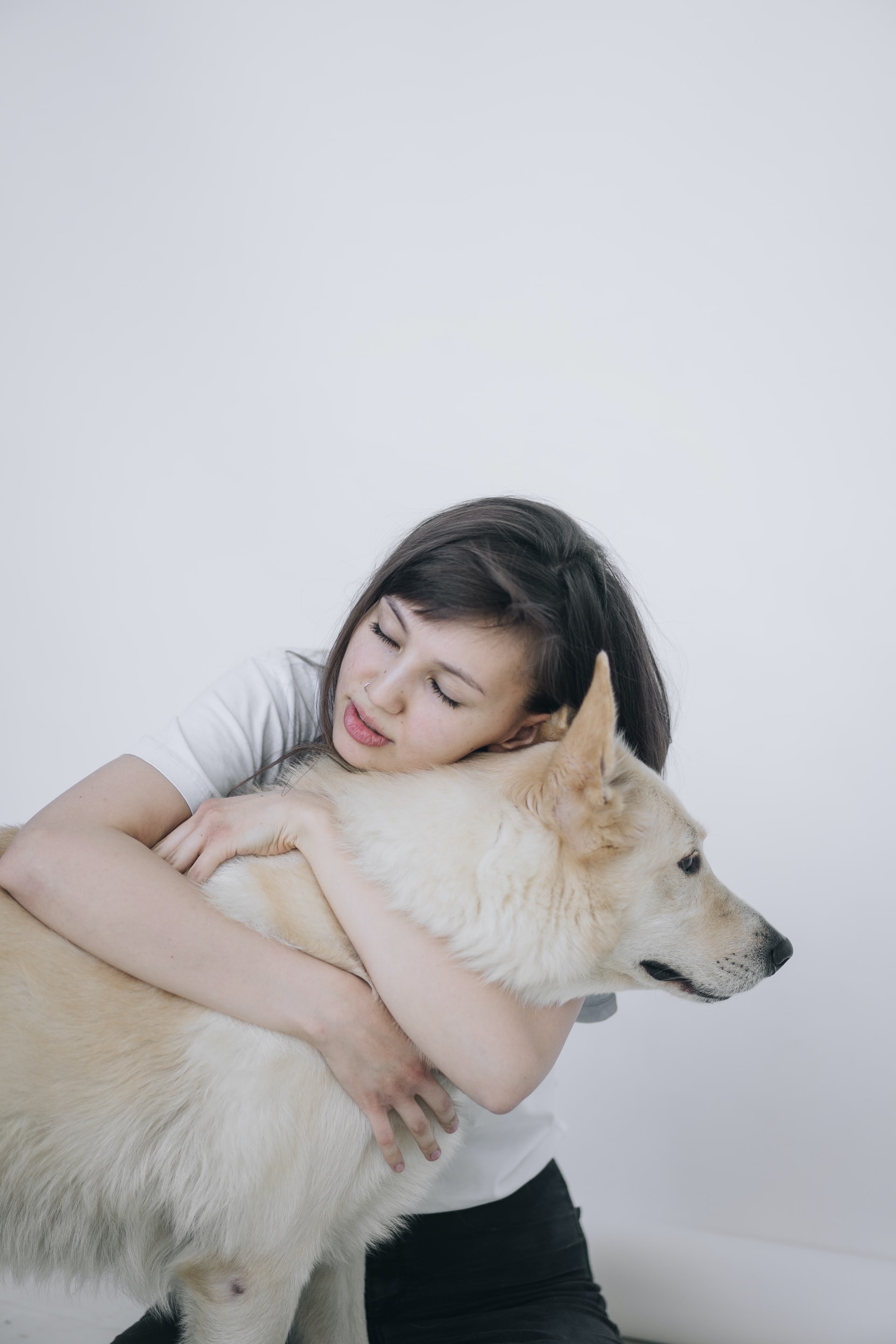A girl hugging a dog
