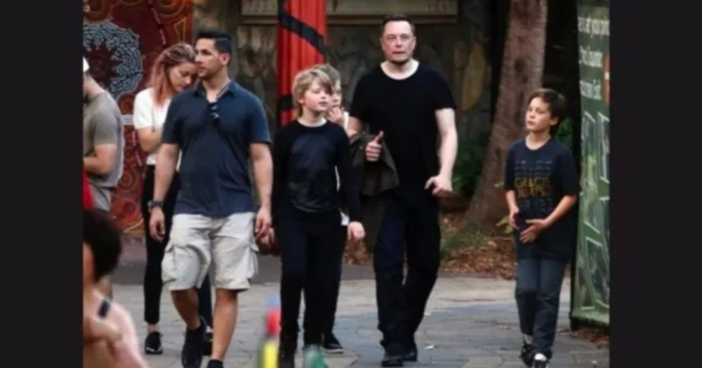 Saxon Musk with his father and brothers walking on the street