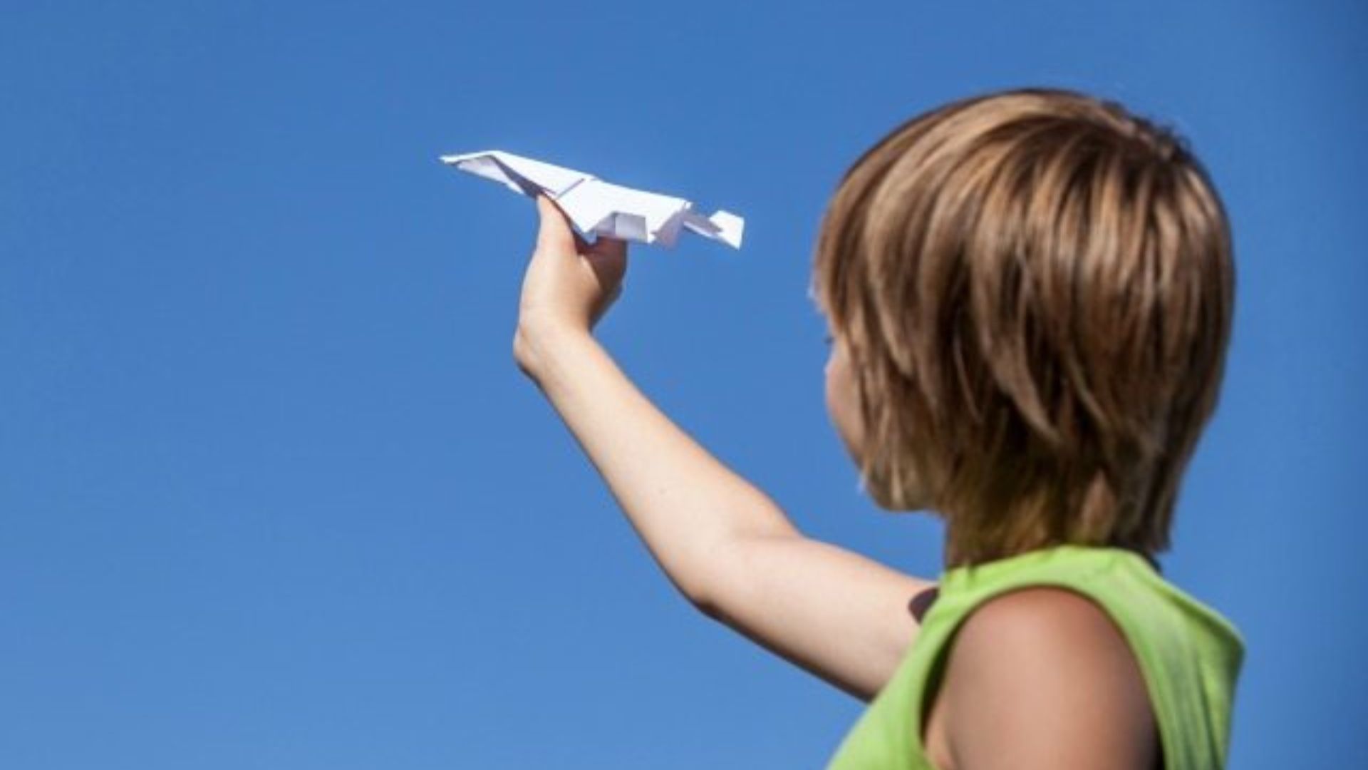 Child Holding A Paper Plane