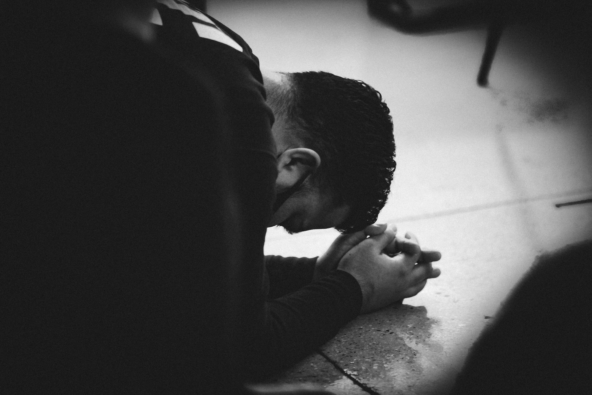 Young man praying on the floor