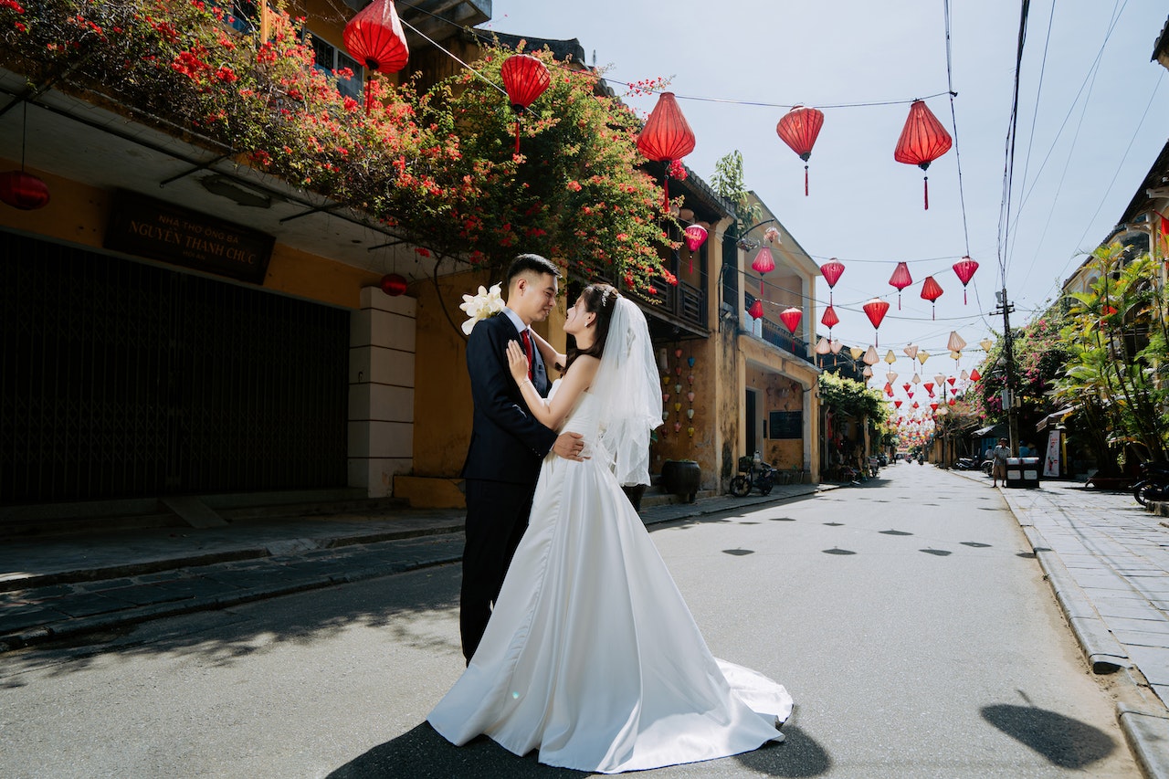 Newlywed Couple Embracing On Middle Of Road