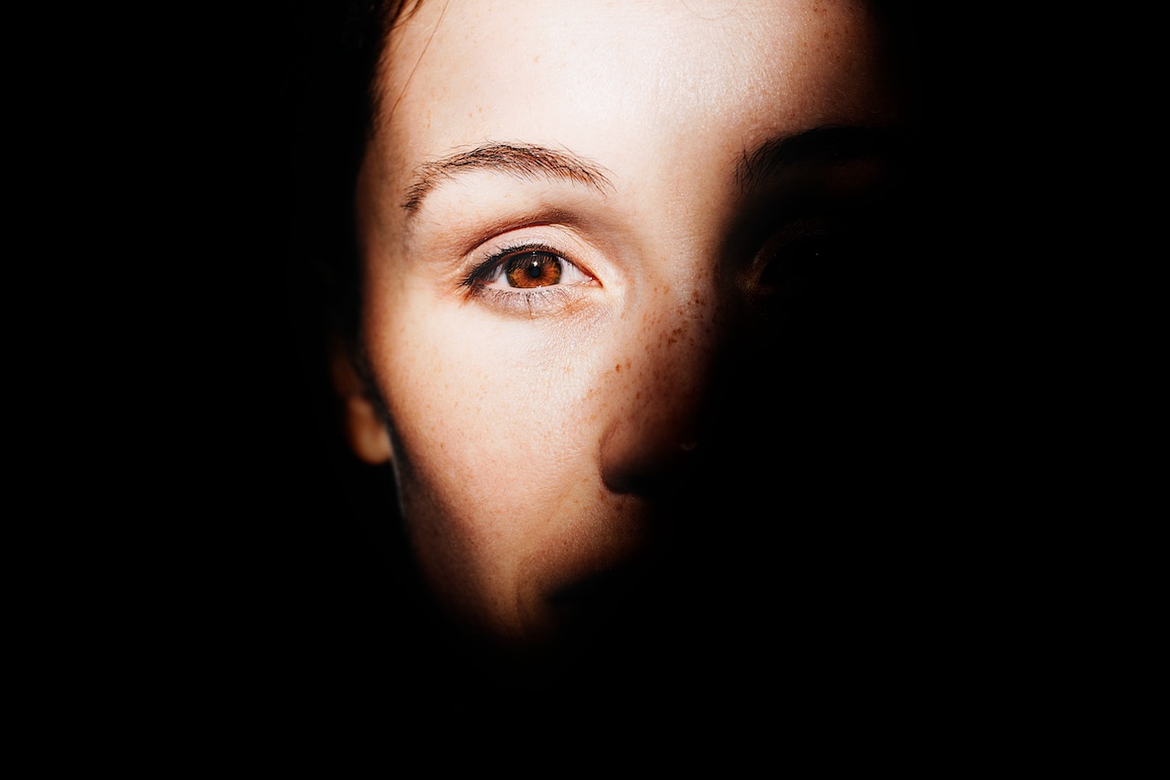 Woman's Half Face Covered In Darkness